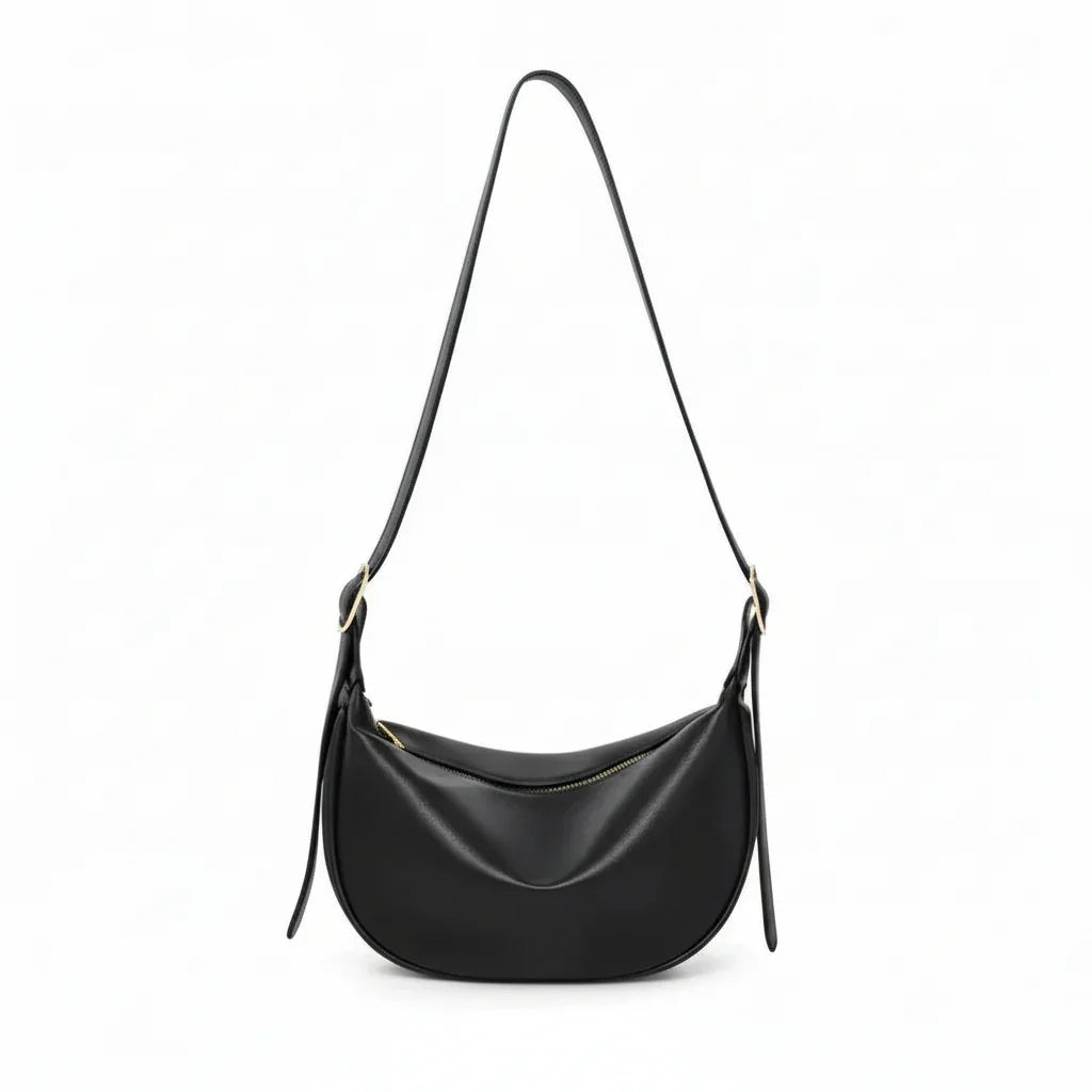 Black leather crescent shoulder bag with zipper, minimalist design on white background