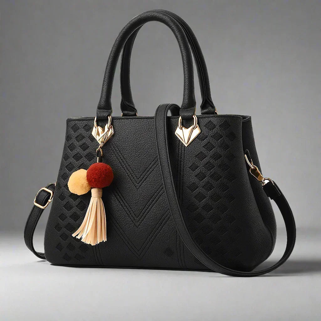 Women's luxury black crossbody handbag with gold accents and tassel charm