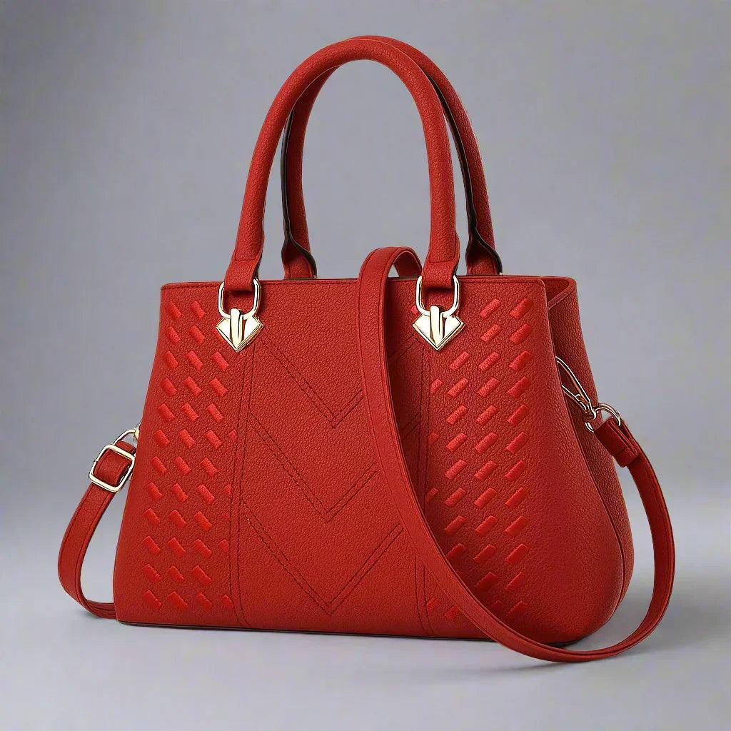 Red women's luxury crossbody handbag with textured pattern and gold hardware