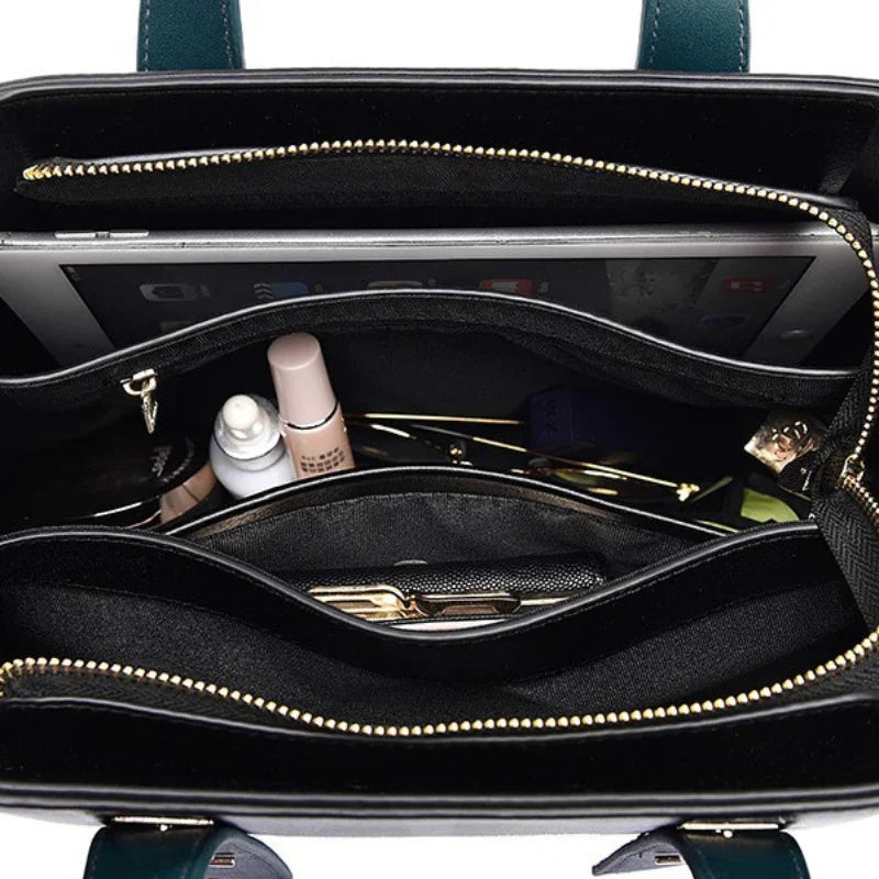 Top view of organized handbag interior with makeup, tablet, and wallet compartments