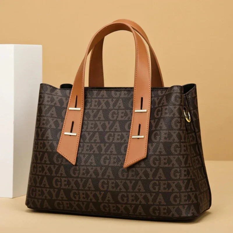 Brown GEXYA logo tote bag with tan handles on beige background