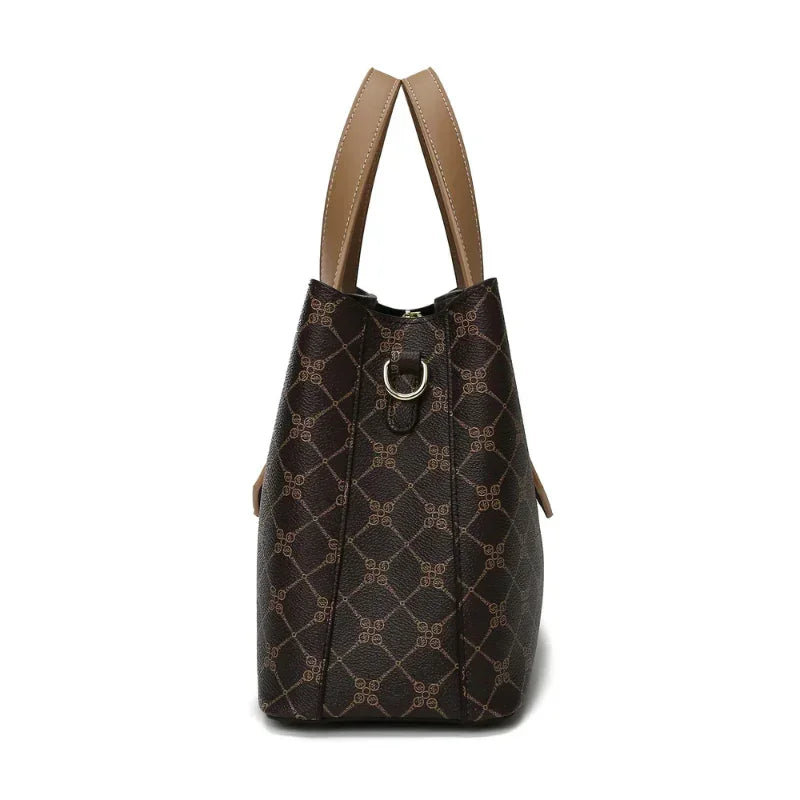Side view of brown patterned leather handbag with tan handles and silver ring detail