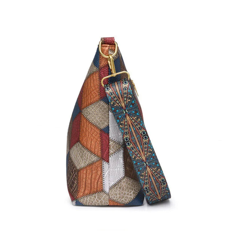 Colorful geometric patchwork handbag with patterned blue and orange shoulder strap