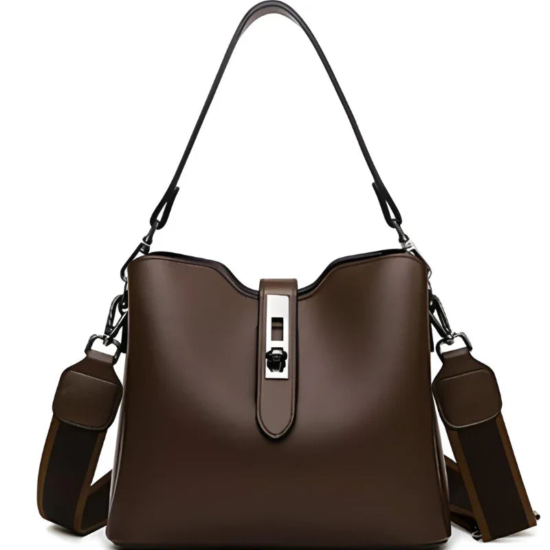 Brown leather handbag with metal clasp and adjustable strap on white background