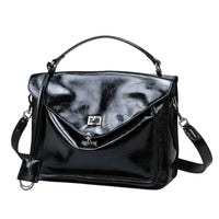 Glossy black leather handbag with top handle and detachable shoulder strap