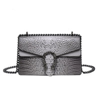 Gray crocodile embossed leather shoulder bag with chain strap and ornate metal clasp