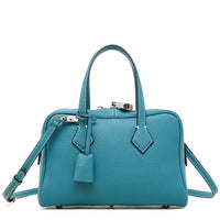 Teal leather handbag with top handles, crossbody strap, silver hardware, white stitching