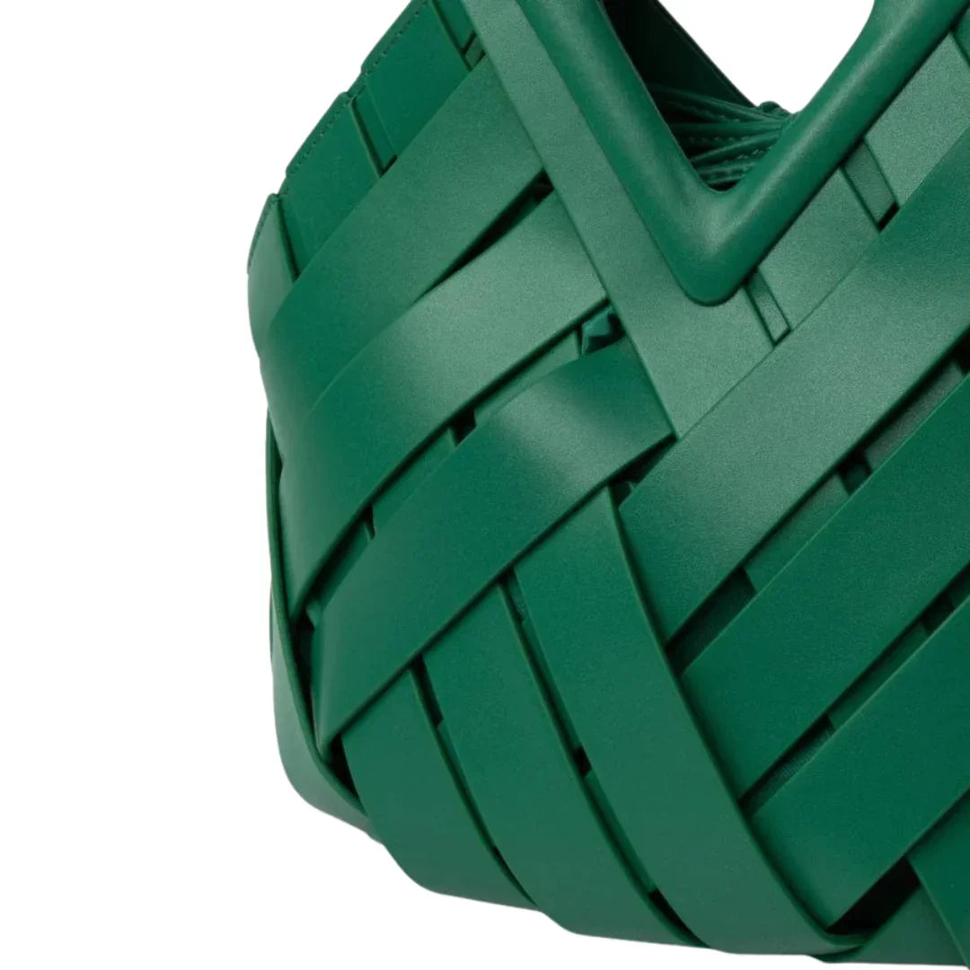 Close-up of a green woven tote bag with overlapping strips and a geometric handle