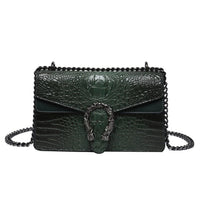 Dark green crocodile embossed leather shoulder bag with chain strap and ornate buckle detail