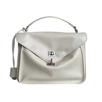 White leather handbag with top handle and silver clasp on white background