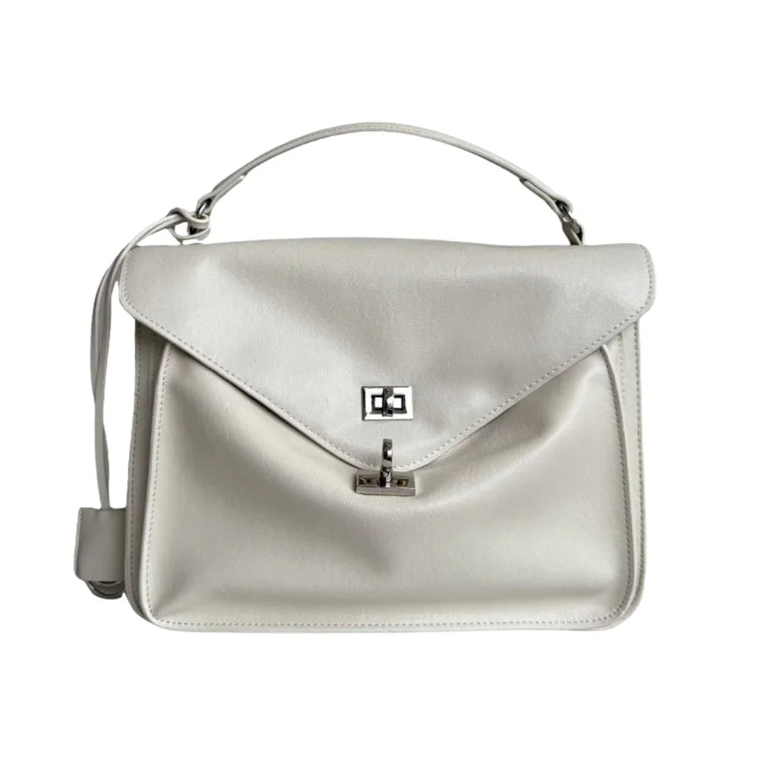 White leather handbag with top handle and silver clasp on white background