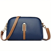 Navy blue leather crossbody bag with brown strap and gold hardware