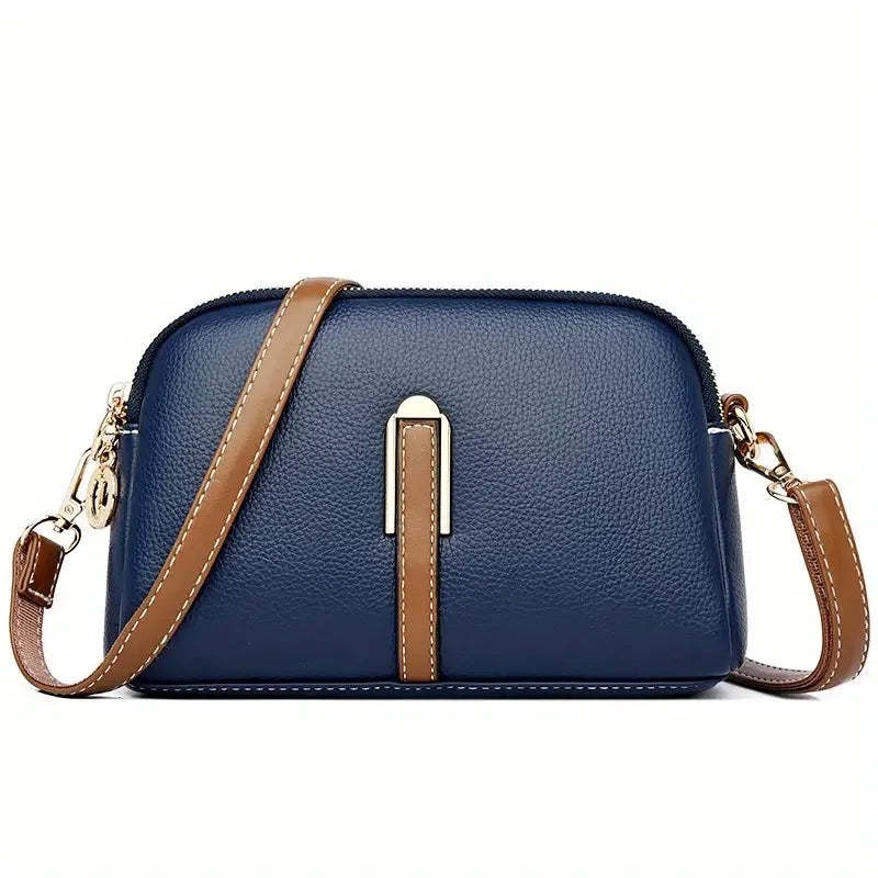 Navy blue leather crossbody bag with brown strap and gold hardware