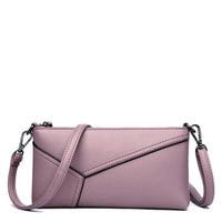 Light purple leather crossbody bag with geometric stitching and detachable strap