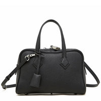 Black textured leather handbag with top handles and detachable shoulder strap