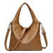 Brown leather tote bag with detachable shoulder strap and textured finish on white background