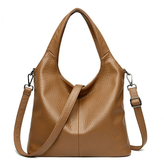 Brown leather tote bag with detachable shoulder strap and textured finish on white background