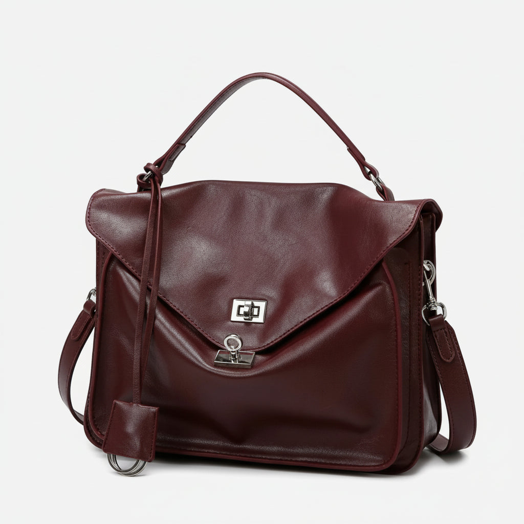 Burgundy leather satchel handbag with silver clasp, top handle, and detachable strap