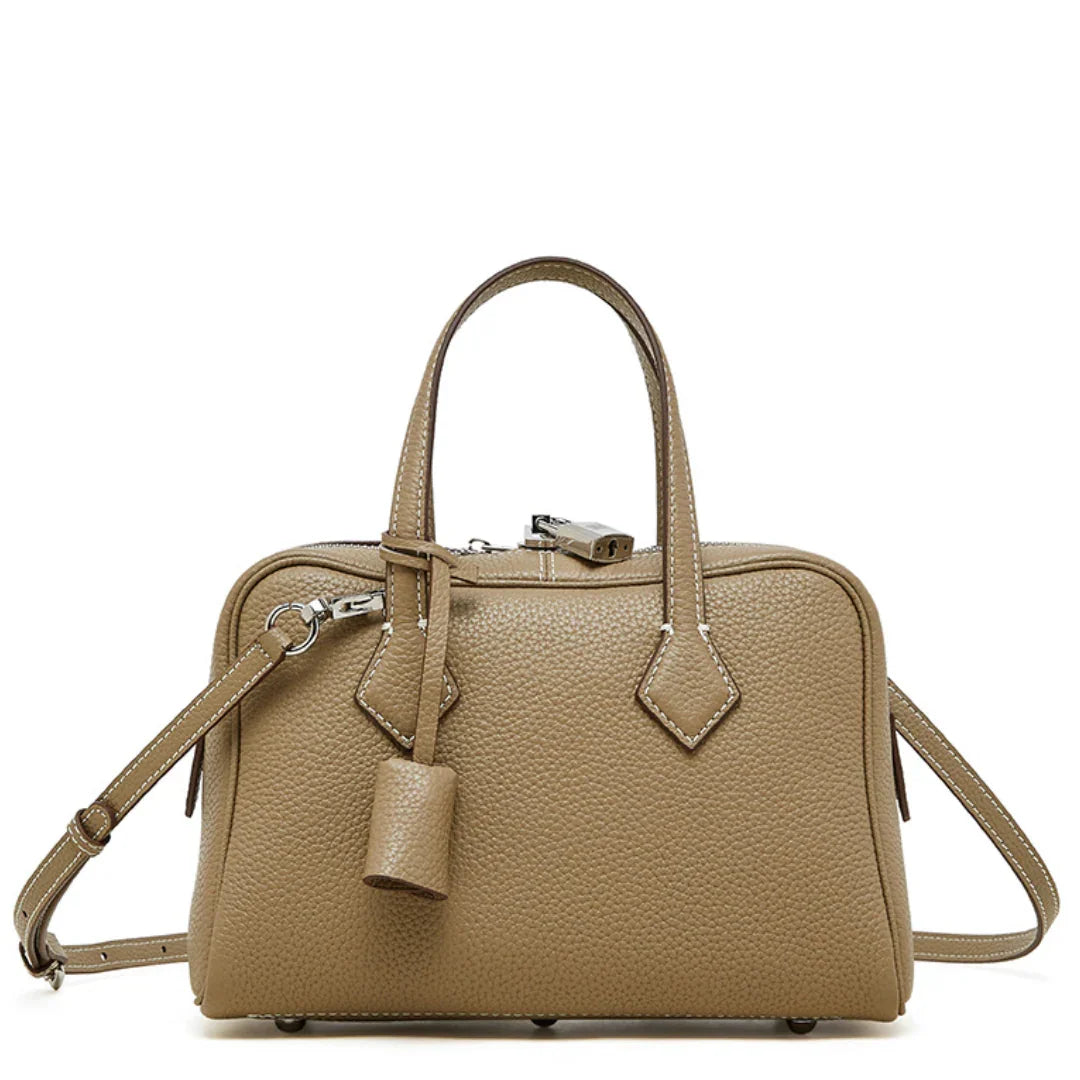 Taupe leather satchel handbag with top handles, detachable strap, and silver hardware