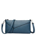 Blue faux leather crossbody bag with embossed texture and detachable strap on white background