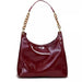 Glossy burgundy leather handbag with gold chain strap on white background