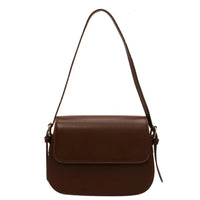 Brown leather shoulder bag with flap closure on white background