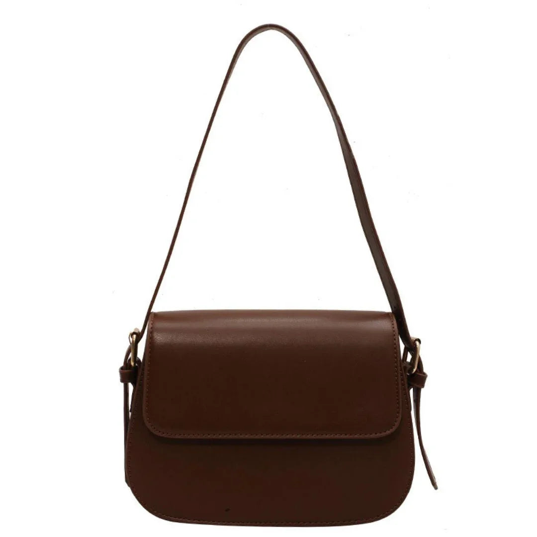 Brown leather shoulder bag with flap closure on white background