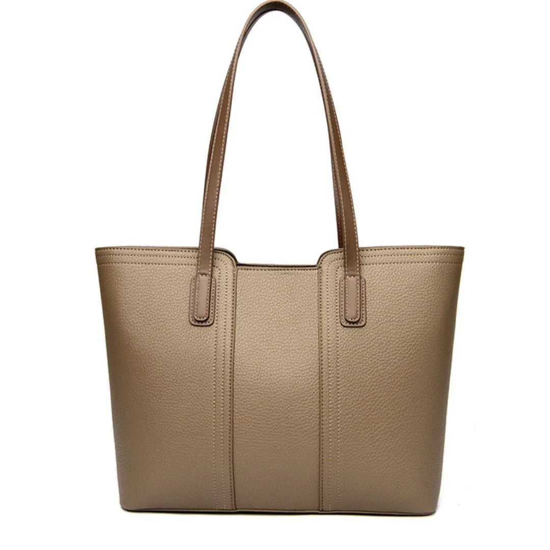 Taupe leather tote bag with double shoulder straps on white background