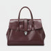 Burgundy leather handbag with top handles and silver clasp on white background