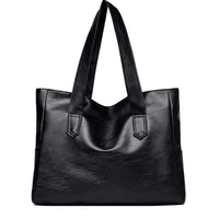 Black leather tote bag with dual handles on white background