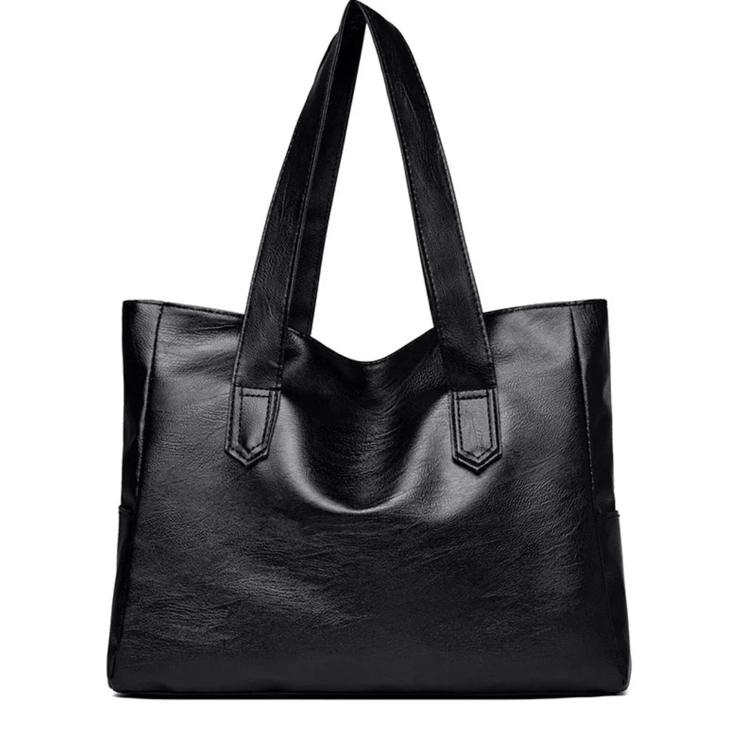 Black leather tote bag with dual handles on white background