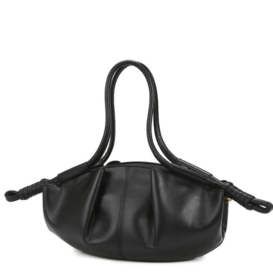 Black leather handbag with double handles and knotted ends against white background