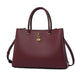 Elegant burgundy leather handbag with gold accents and dual handles, fashion accessory