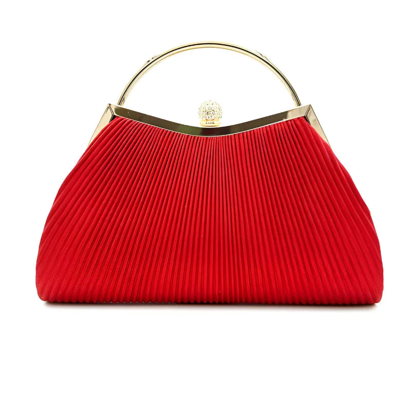 Red pleated handbag with gold metal handle and clasp on white background
