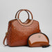 Glossy brown crocodile-pattern handbag with matching cosmetic pouch on white background