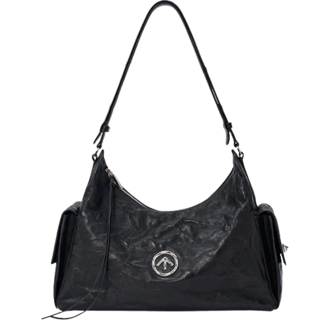 Black leather shoulder bag with silver round logo, front zipper, and side pockets
