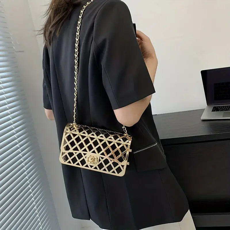 Woman in black blazer with gold lattice chain shoulder bag in modern office setting
