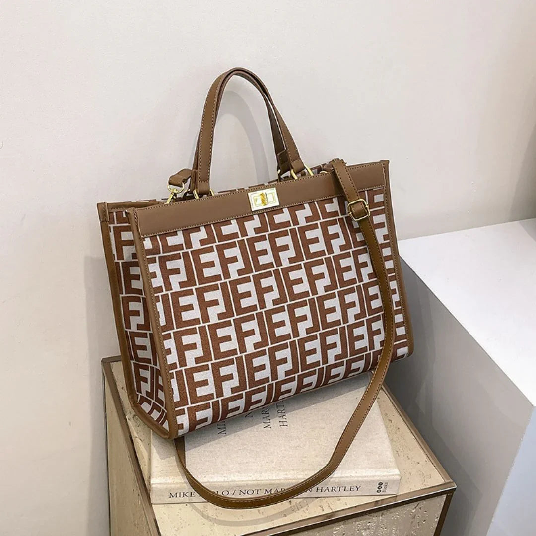 Brown and white tote bag with geometric FE pattern on a beige surface