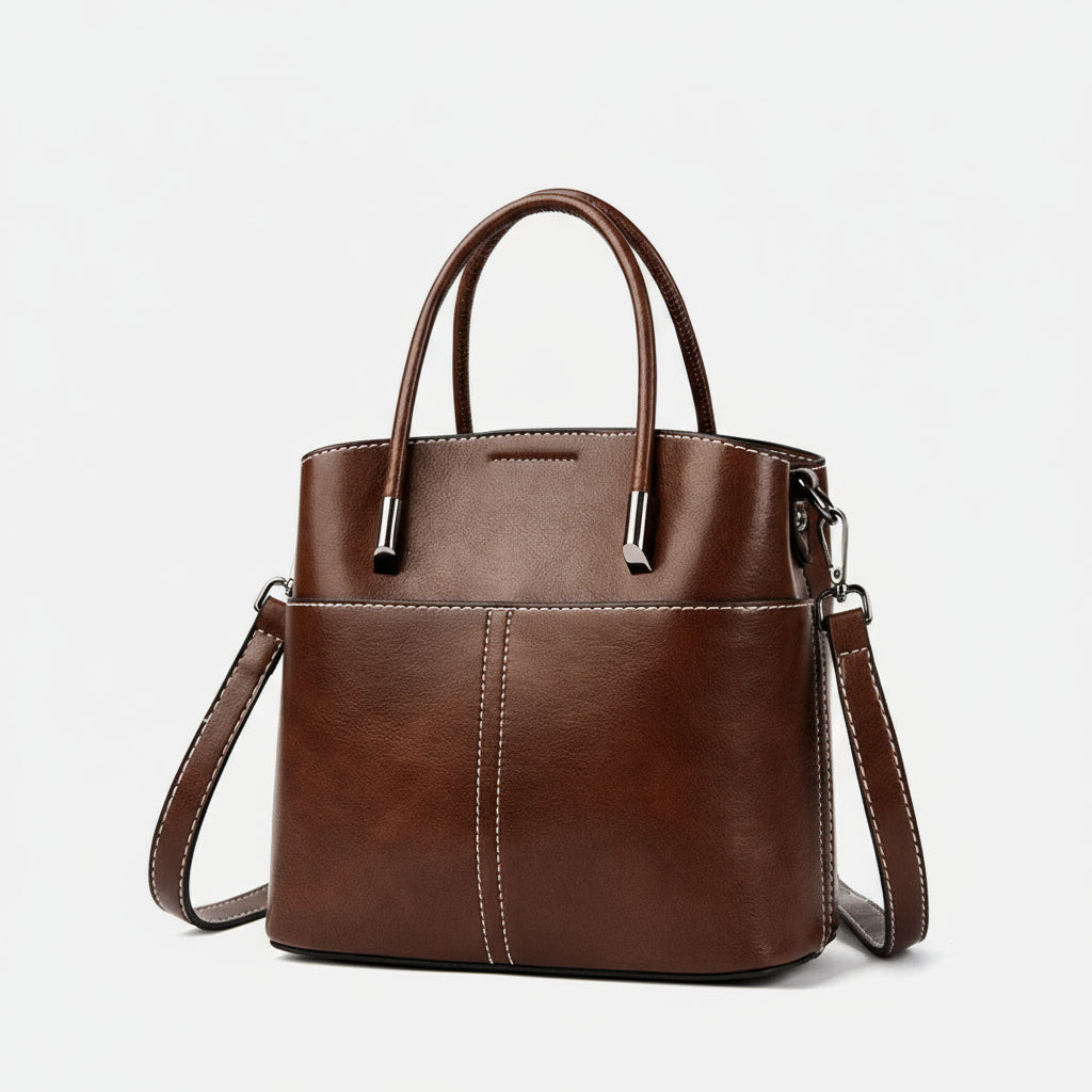 Brown leather handbag with white stitching, top handles, and detachable shoulder strap