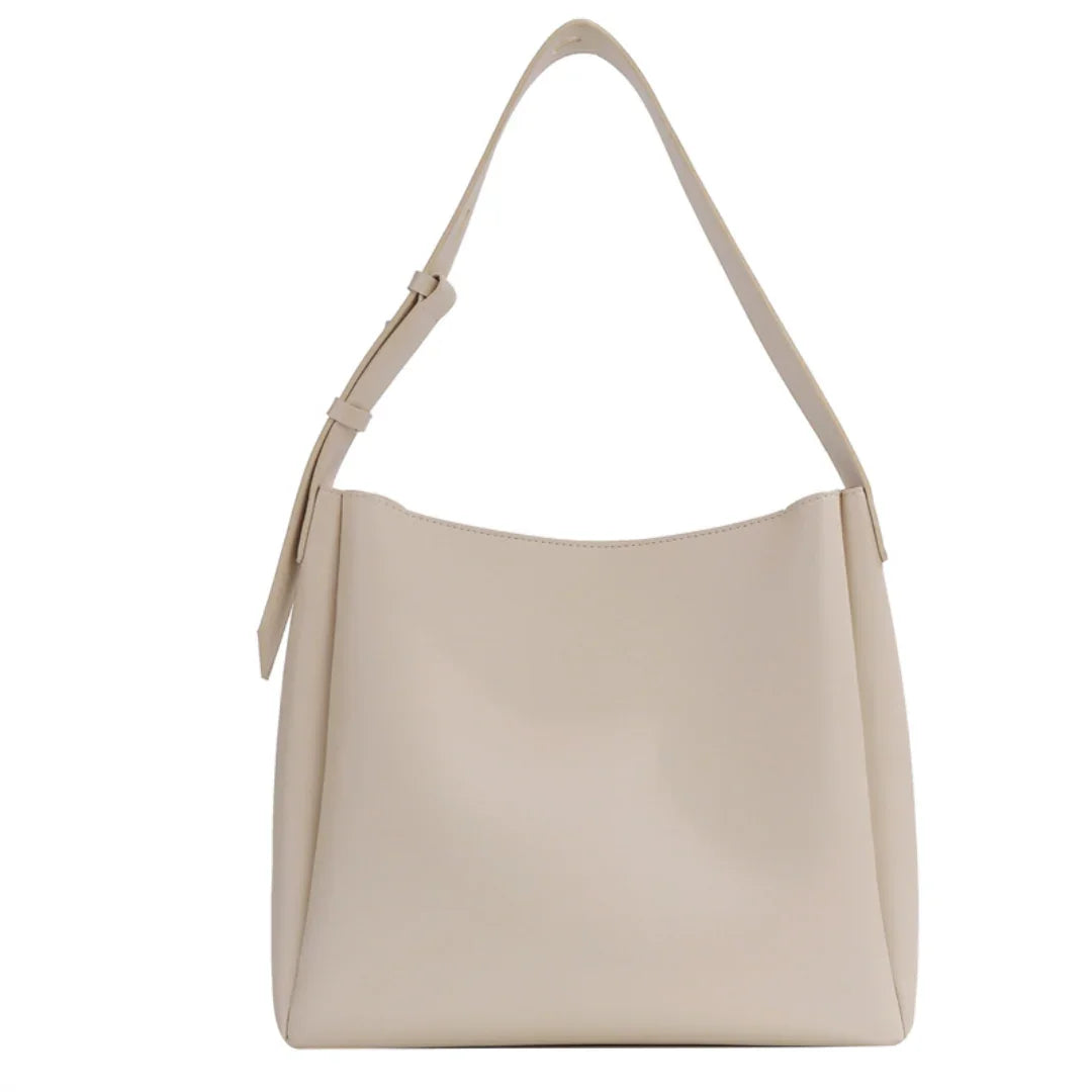 Beige leather shoulder bag with adjustable strap, minimalist tote style