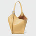 Yellow leather bucket bag with adjustable strap and silver buckle on white background