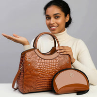 Smiling woman with brown crocodile leather handbag and matching glossy pouch on table