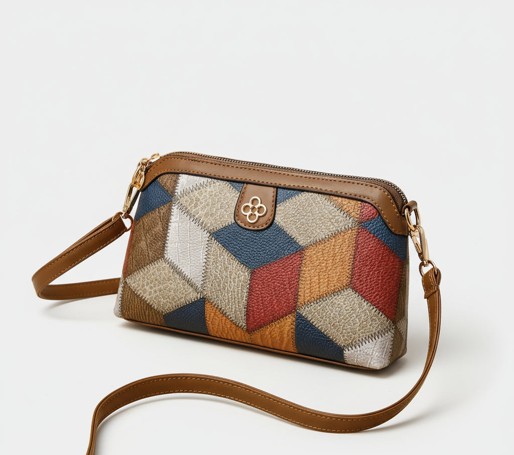 Colorful geometric patchwork leather crossbody bag with brown strap on beige background