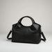 Black leather handbag with round handles and detachable shoulder strap on a white background