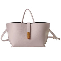 Light pink leather tote bag with gold accent, top handle, and crossbody strap