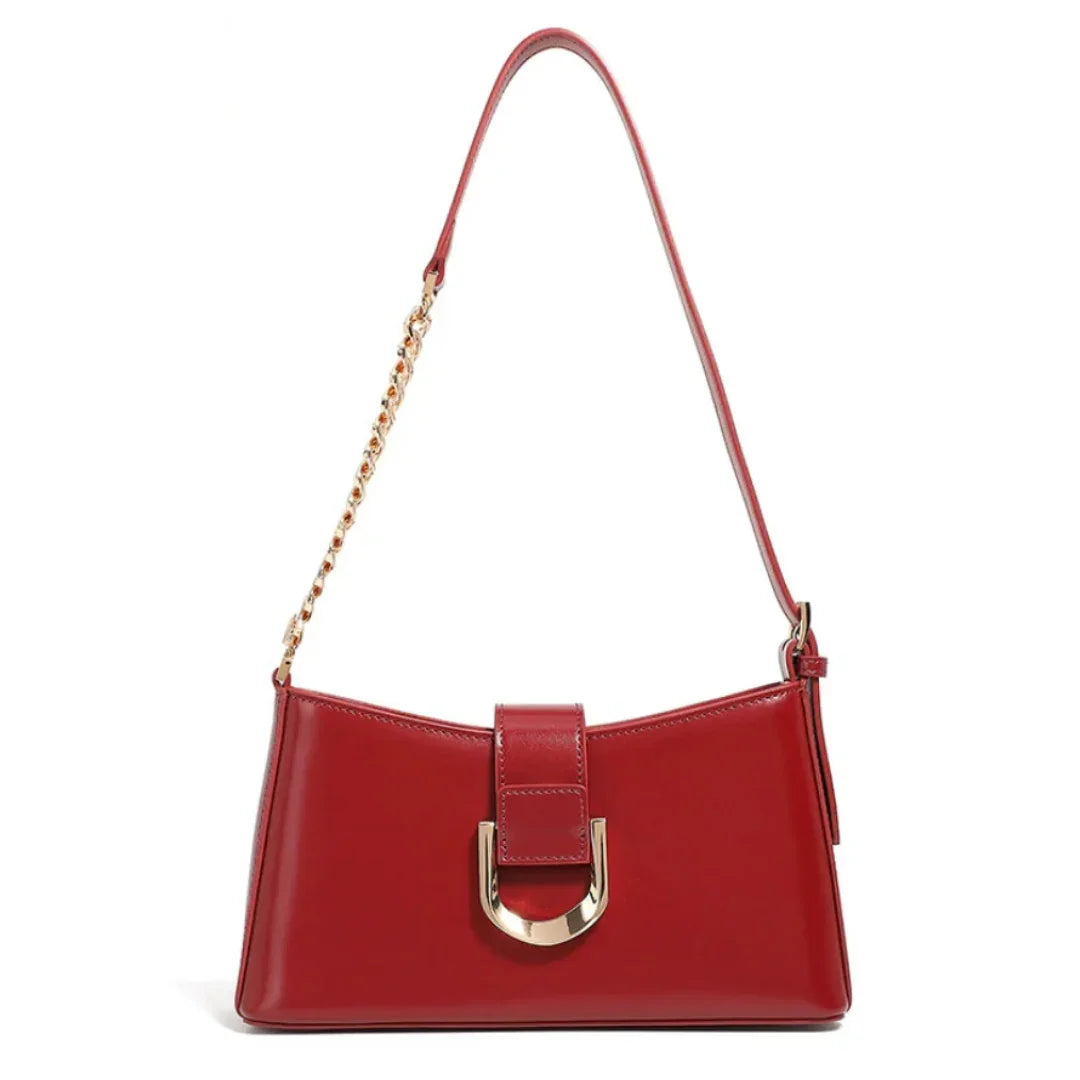 Red leather shoulder bag with gold chain strap and metallic buckle front detail