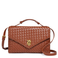 Brown woven leather crossbody bag with gold clasp and adjustable strap on white background
