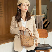 Woman in beige blazer and beret with brown patterned handbag in a modern cafe