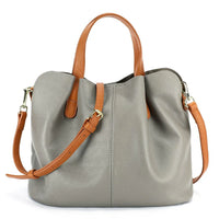 Gray leather tote bag with tan handles and adjustable shoulder strap, gold hardware