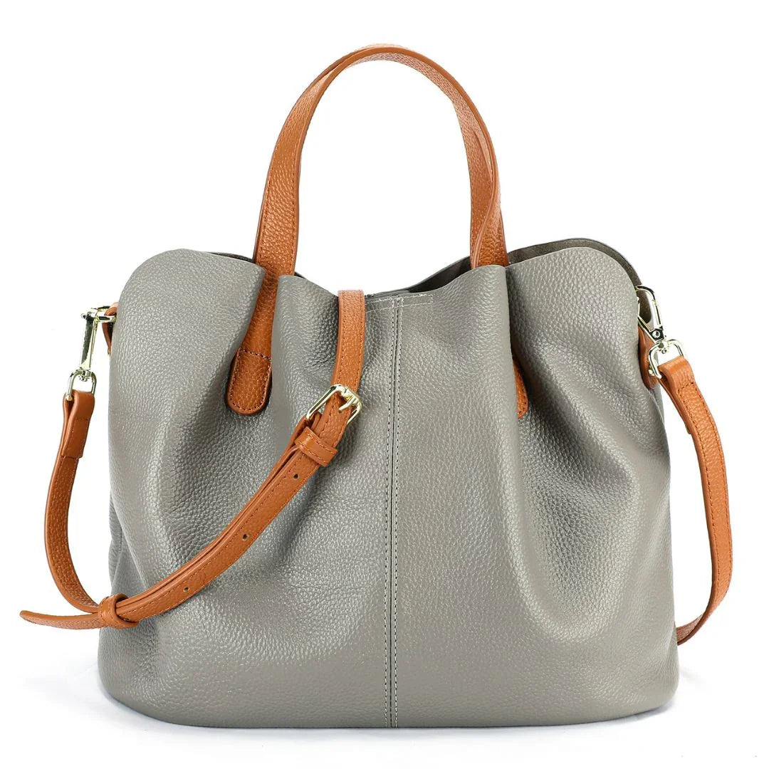 Gray leather tote bag with tan handles and adjustable shoulder strap, gold hardware